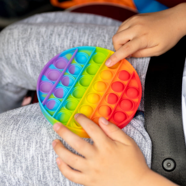 Round pop it stress toy with colorful bubbles.